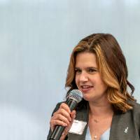 Laura Aikens speaking on stage